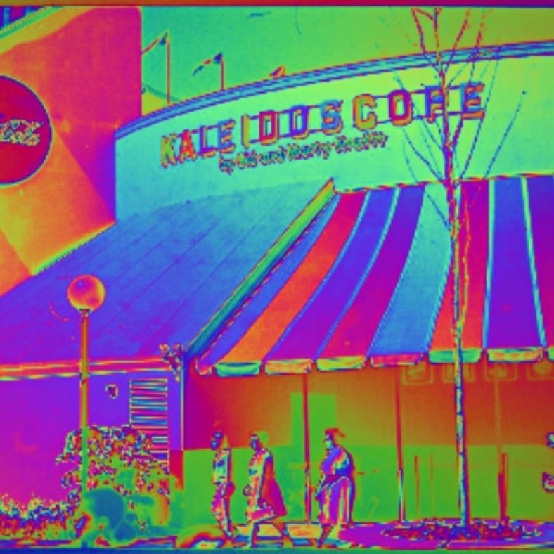 Thermal-style image of a cafe exterior with people walking by.
