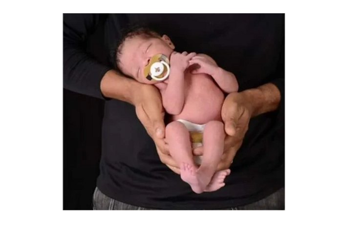 Titus, being held by his father Philp