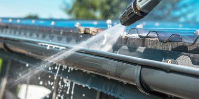 Gutter being pressure washed