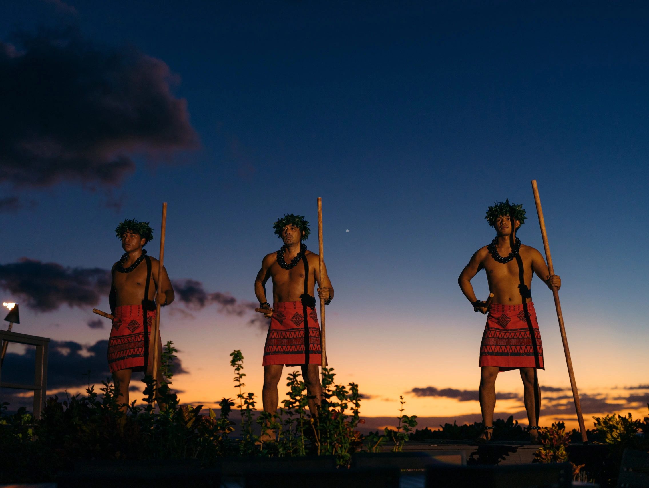 Myths of Maui performers on the oceanfront stage at sunset.