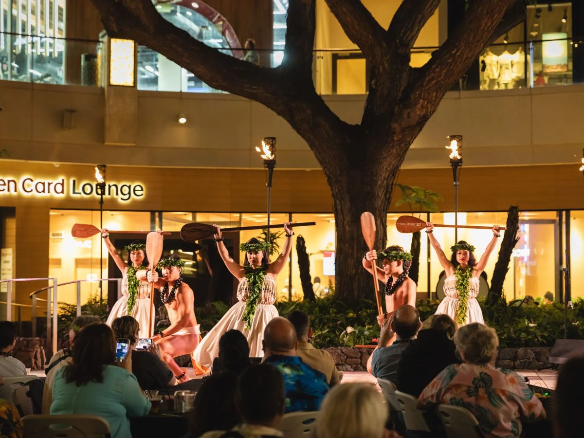 Polynesian dancers performing at Queens Waikiki Luau in International Market Place