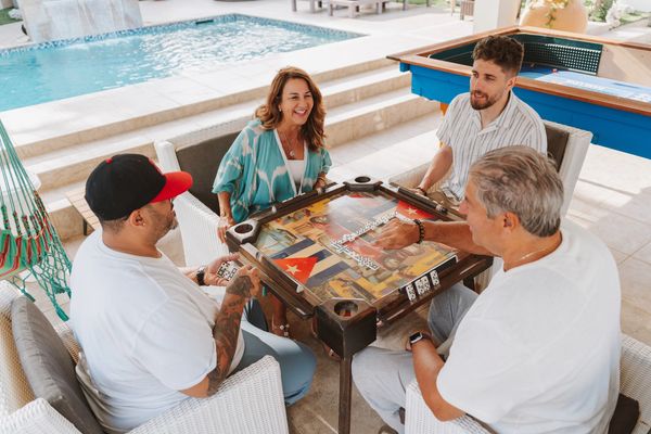 Guests playing dominoes in the outdoor entertainment area at Paradise in Aruba vacation rental
