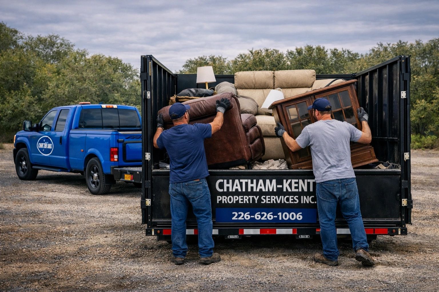 Two men loading furniture into a Chatham-Kent Property Services truck.