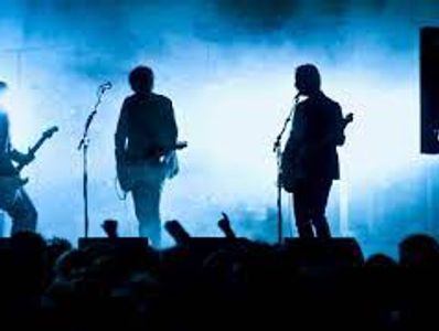 3 guitarist on a smokey stage