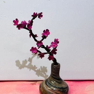 Cherry blossom branch in a marble ceramic vase.