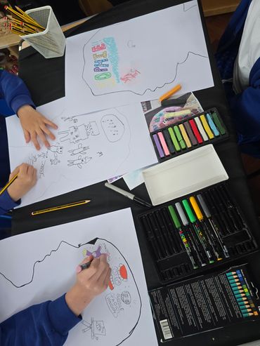 People drawing and coloring on paper with chalk pastels and markers.