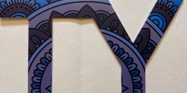Decorative letters 'T' and 'Y' with intricate blue and black mandala patterns on a white background.