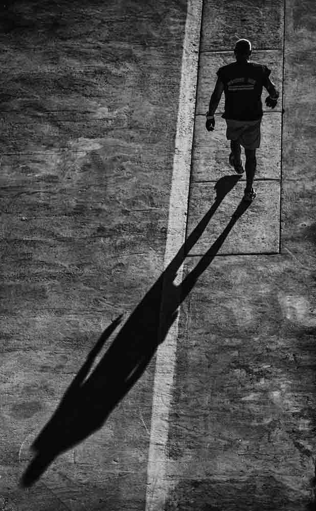 Man walking away, great shadow