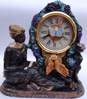 Decorative clock with a seated woman and ornate details.