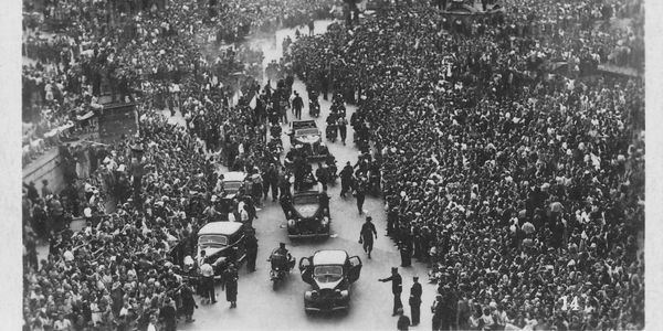 Massive crowd lines the streets for a historic motorcade procession.