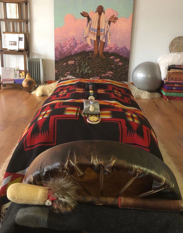 Lodge sanctuary healing space, set up ready for the client with a massage table,, blankets, sacred c