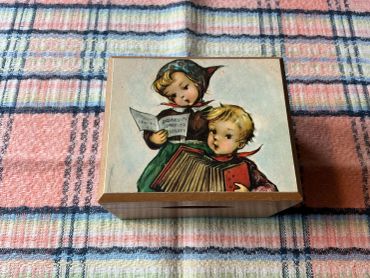 Decorative wooden box with vintage children illustration.