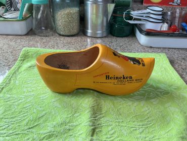 Yellow wooden clog with Heineken branding.