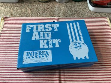 Blue first aid kit box with vintage design.