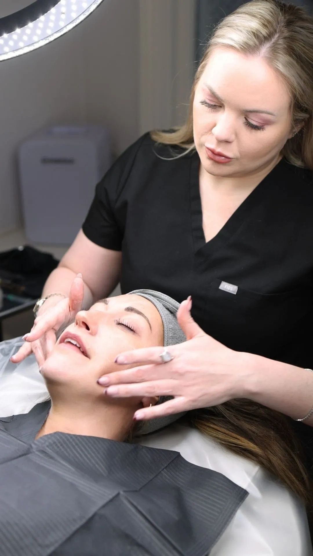 Facial treatment with beautician and client.