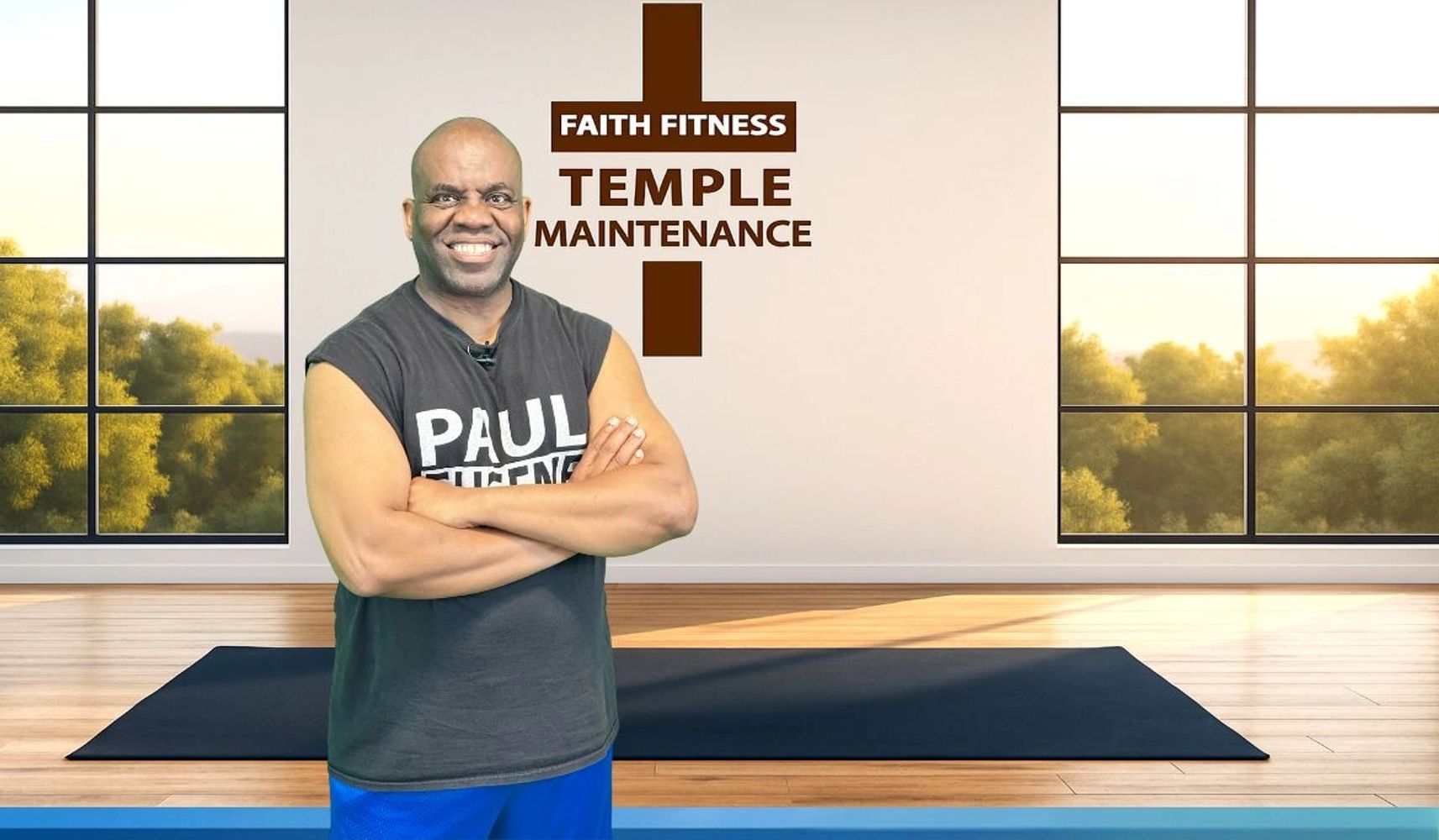 Man smiling in a fitness studio with Faith Fitness Temple Maintenance sign.