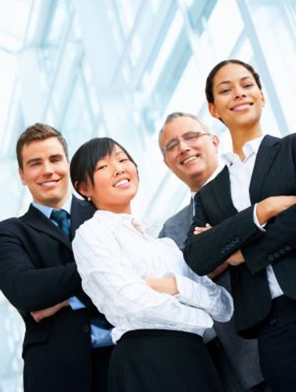 Confident business team posing with arms crossed.