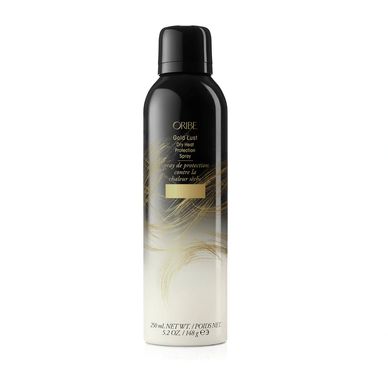 Oribe Gold Lust Dry Heat Protector Spray in a black and white bottle.