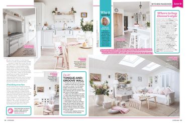 Bright, cozy kitchen and living room with white decor and floral accents.