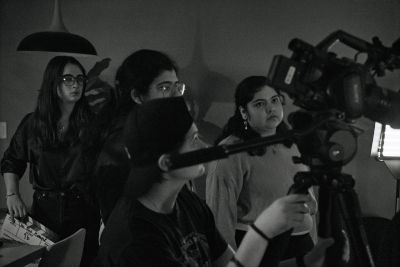 Group filming a scene with camera equipment.