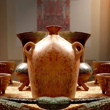 Ancient ceramic vessels displayed on a textured surface with artistic lighting.