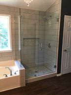 Replacing the fiberglass shower with an expanded tile shower space gives an elegant feel to this master bathroom