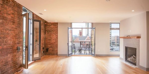 Bright loft apartment with exposed brick and balcony.