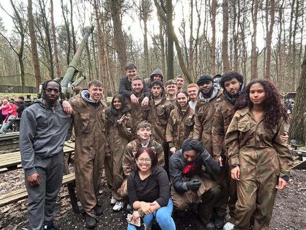Group of people in camouflage suits in a forest.