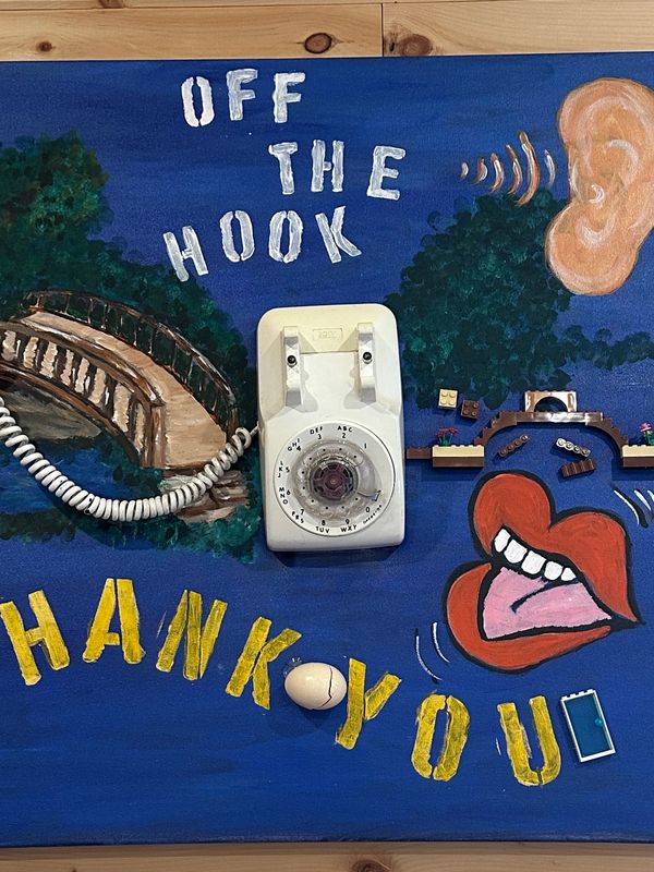 Creative wall art with a rotary phone and the text 'Off the Hook, Thank You'.