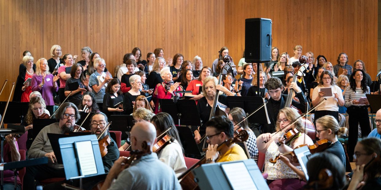 rehearsal for a showcase performance featuring orchestra and chorus