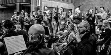 Orchestra and singers rehearsing for a Showcase performance