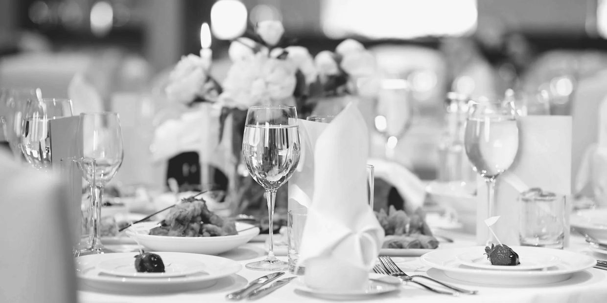Elegant table setting with folded napkins and glassware for a formal event.