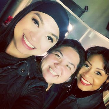 Three women looking forward and smiling