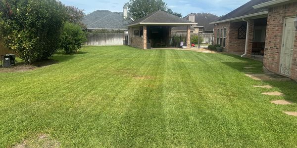 Well-maintained backyard lawn with a small pavilion.