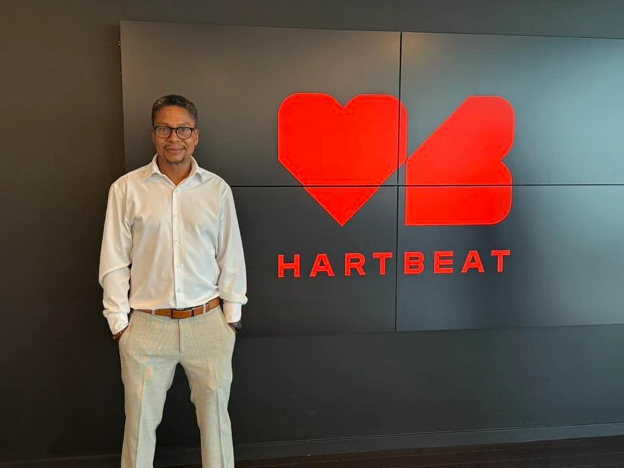 Sean Reid standing in front of the HartBeat logo following a meeting at the company’s offices.