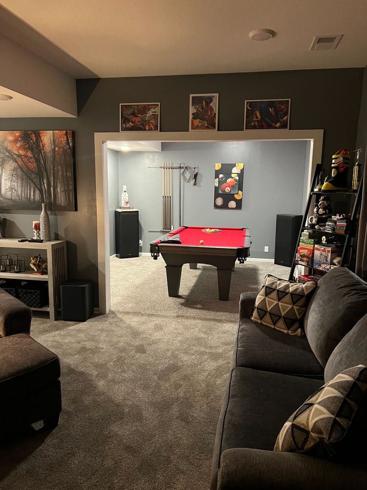Cozy living room with a red pool table in an adjoining game area.