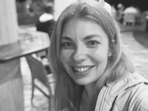 A black and white selfie where I am smiling at the camera