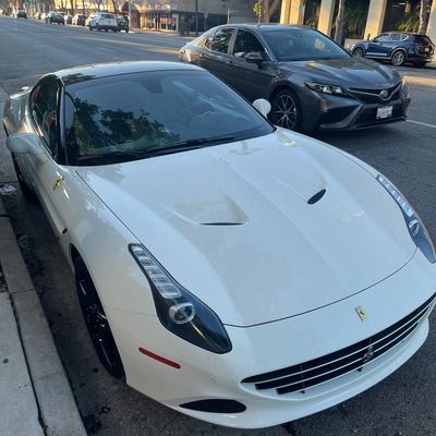 Ferrari at curb with valet sign, representing Always Valet LA.