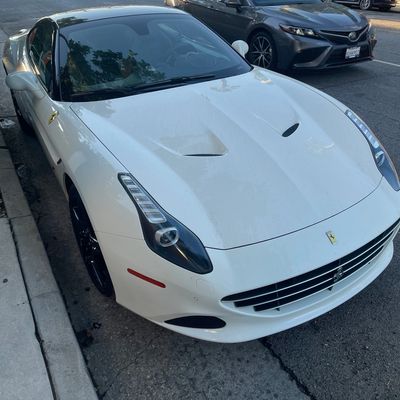 Ferrari at curb with valet sign, representing Always Valet LA.