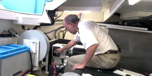 Man operating equipment in a confined mechanical space.