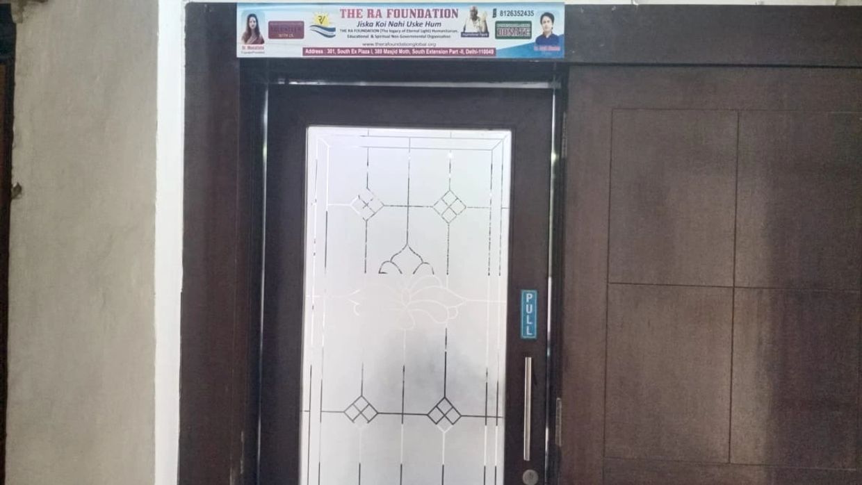 Entrance door of The RA Foundation with frosted glass and a pull handle.
