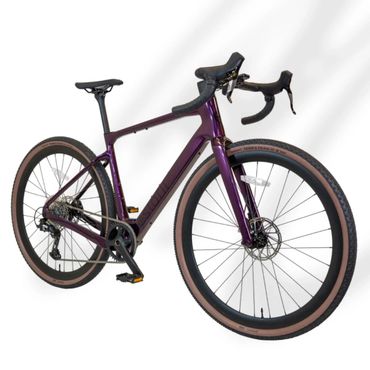 A sleek purple road bike with tan sidewall tires and drop handlebars.