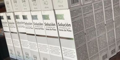 Boxes of silver ion antiseptic solution lined up on a shelf.