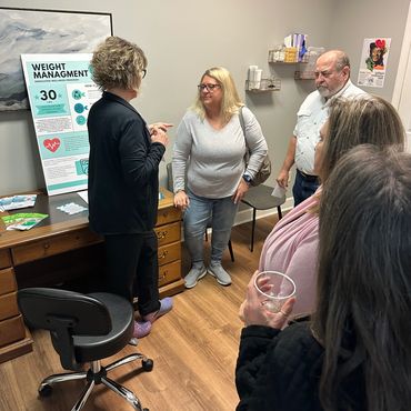 Nurse Practitioner discusses weight management with patients in Wellness clinic 