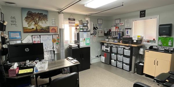 Organized medical lab workspace with labeled storage bins and biohazard waste container.
