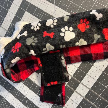 Reversible flannel dog coat. Plaid on one side and paw print pattern on other side.