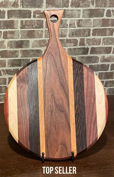 It's Party Time! Exotic woods , 
18" (with handle) x 12"  x 3/4" Pizza/Charcuterie/Serving Board