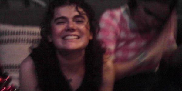 Two people enjoying a moment together, one smiling brightly.