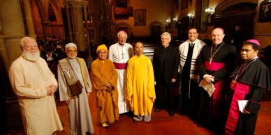 Religious leaders of different faiths stand together inside a church.