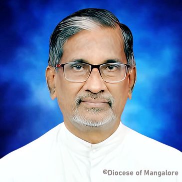 Portrait of a man with glasses against a blue background.